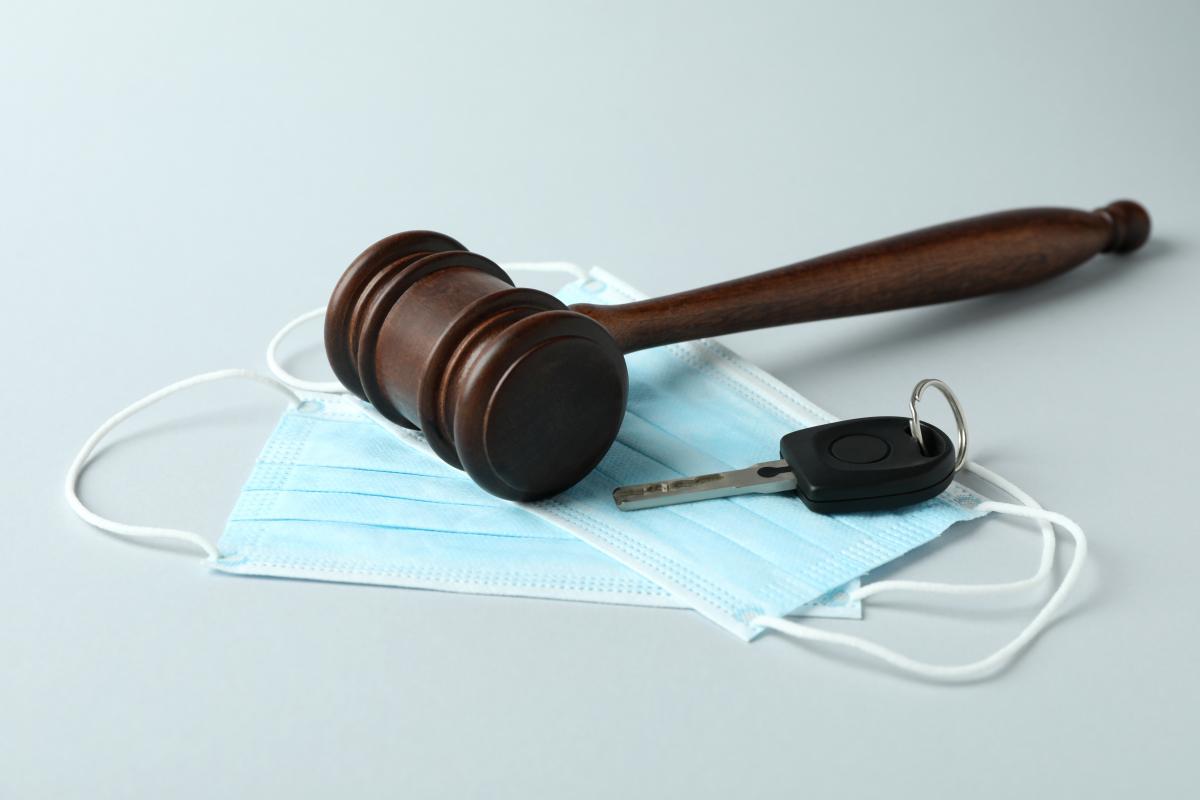 judge gavel key and medical masks on white background