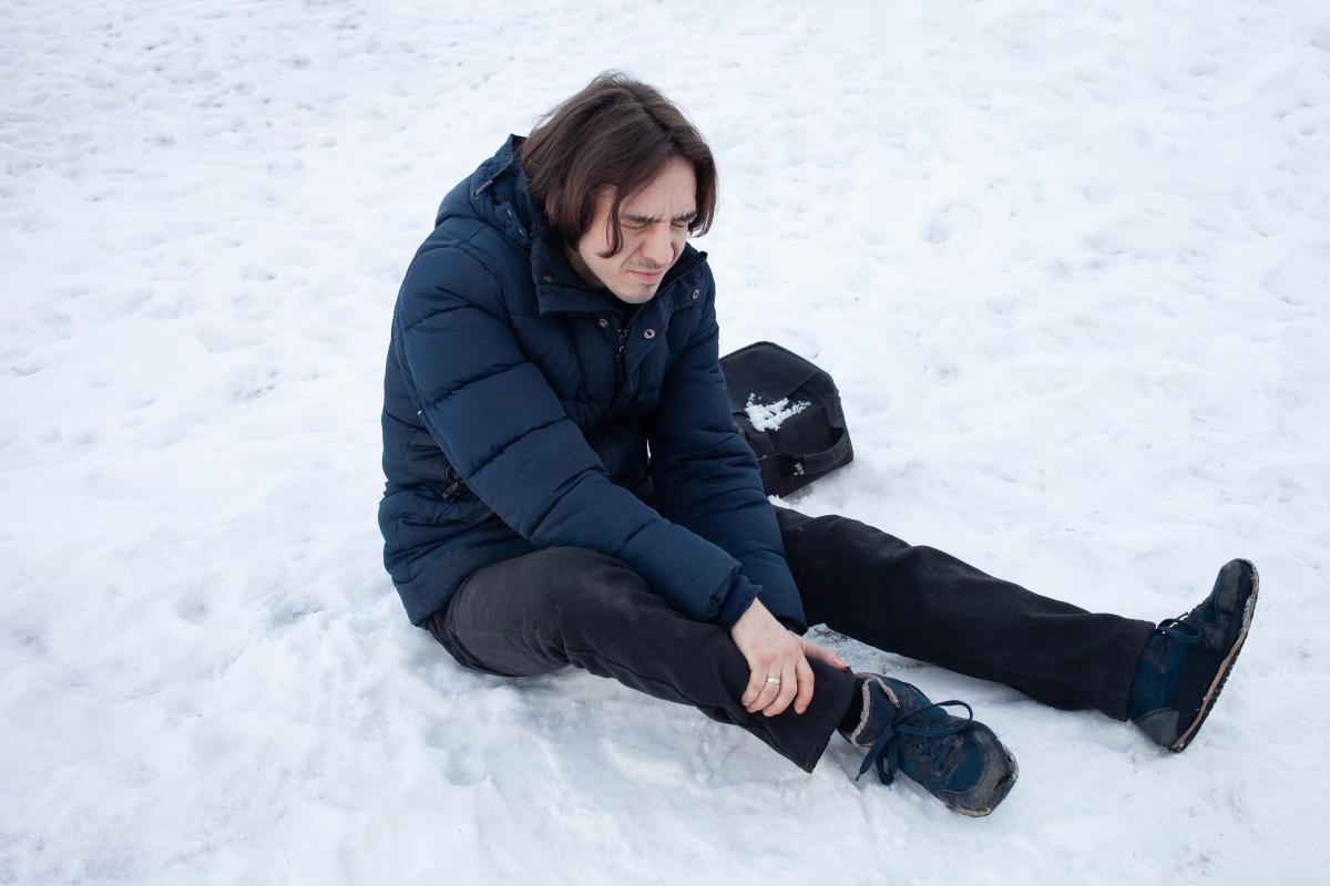 Man Falling in the Snow Holding His Ankle