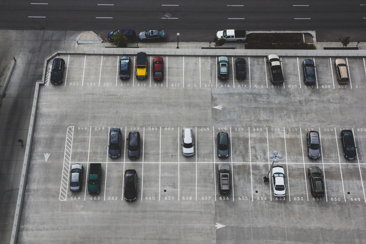 Overview of Parking Lot with Cars Parked in Some Spots