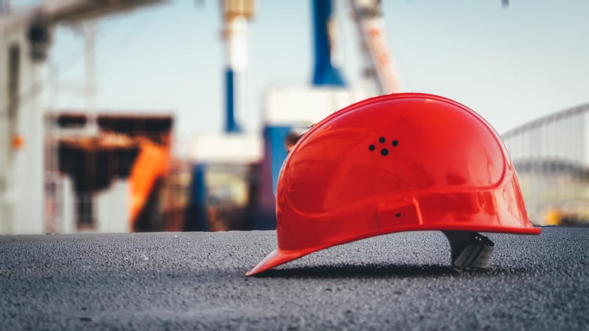Hard hat set on the ground at construction site