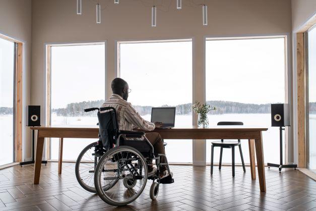  Man with disability working in front of laptop