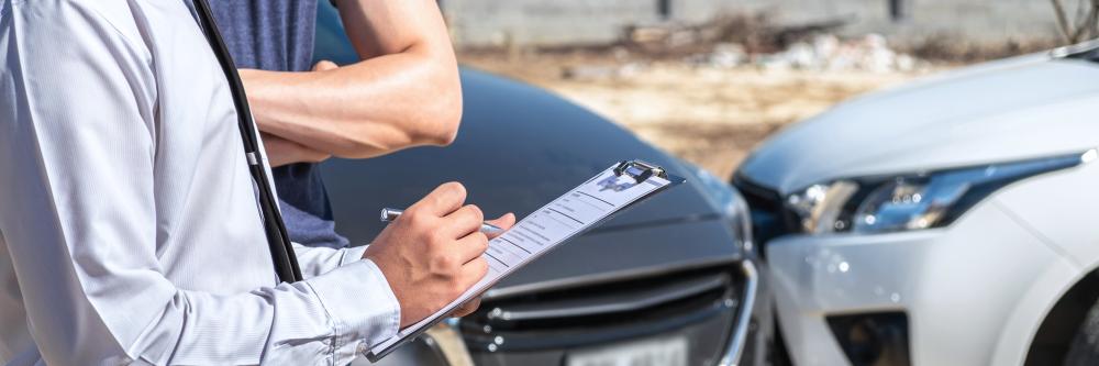 Insurance gent Examining A Car Accident