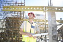 Construction worker looking at construction site