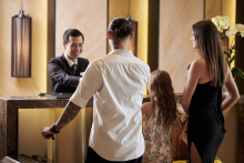 Family Checking Into Hotel